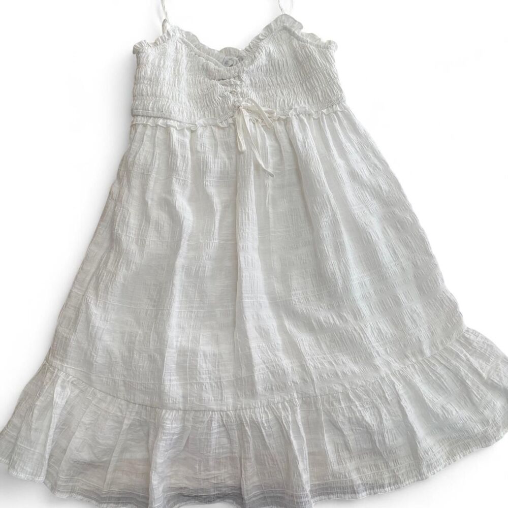 White cotton babydoll dress with ruffles and tie detail